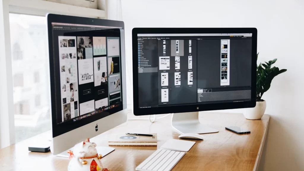 web-design-amplite-media-two-computer-screens-on-table